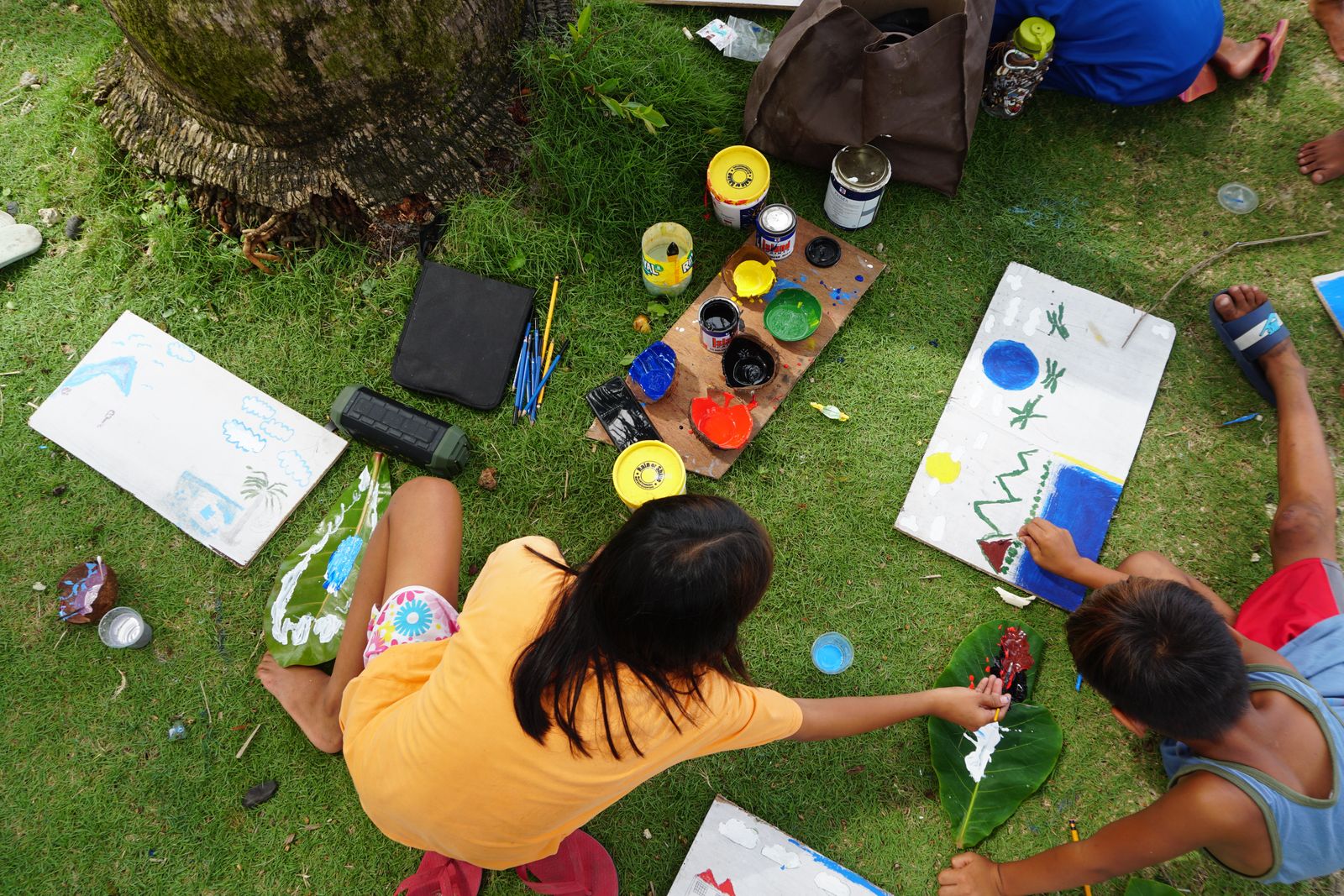 A group of kids painting together outdoors in a park &mdash; the kind of colorful, hands-on making BR Maker Workshop runs every Tuesday in the Hudson Valley.